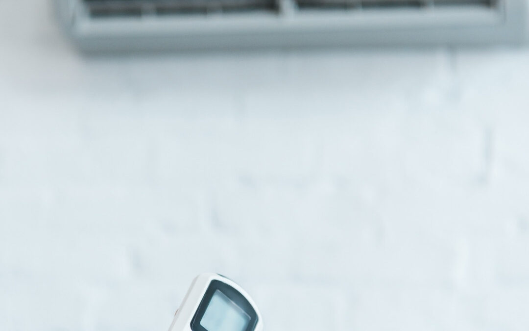 man holding aircon remote